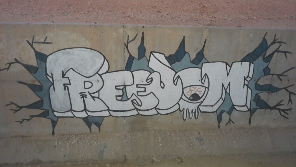 Graffiti on an urban wall representing freedom and vandalism in street art